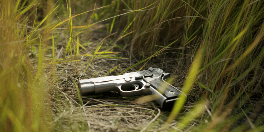a photograph of a handgun lying on the g N8cQml8AQTiRLHvEVVItfQ UKDzUJNeSgeWhPcSuvvEuQ 1