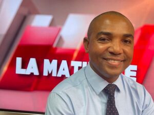 Accueil 80 Portrait institutionnel de Soula Saïd-Souffou accompagné d’un visuel évoquant la reconstruction et les enjeux sociaux à Mayotte un an après le cyclone Chido.